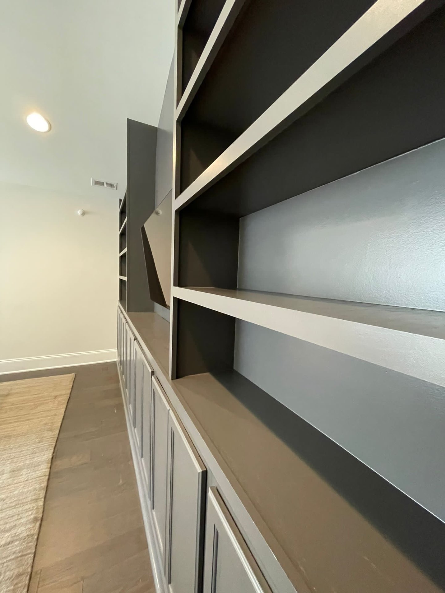 Close view of built-in shelving finished in a smooth gray lacquer