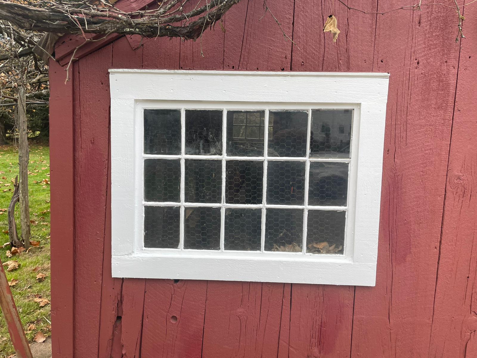 Crisp white painted window trim on a red barn wall