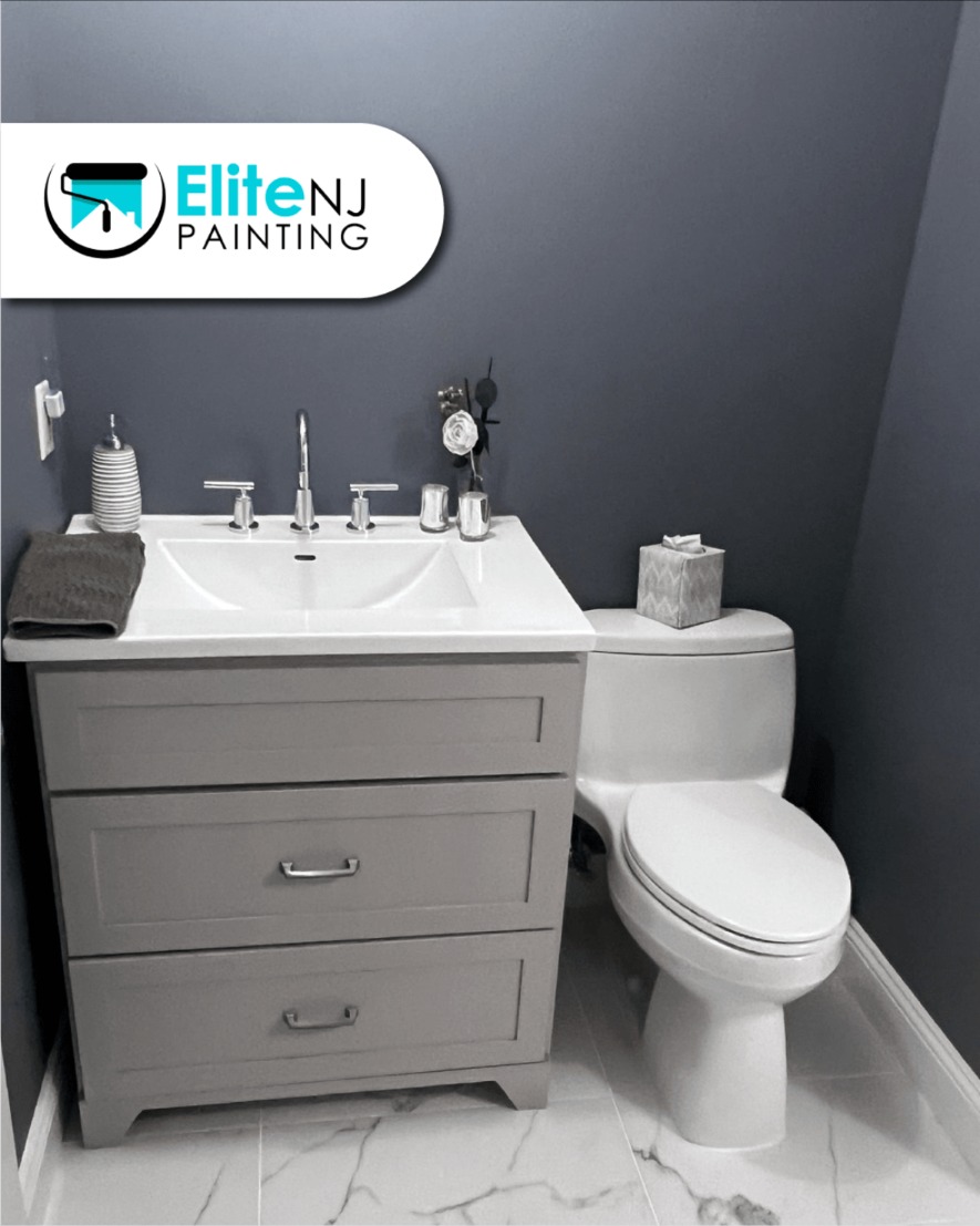 Powder room with a gray painted vanity and deep slate blue walls